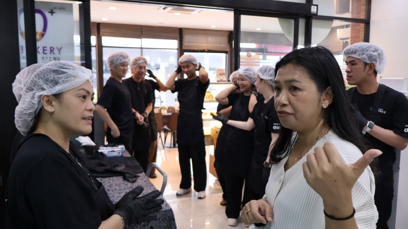 Ms. Wilailekha Somprach, Manager of 60+ Plus Project and Ms. Maria Concepcion Macabales, Residence Manager engaging in a conversation in front of Bakery Room.