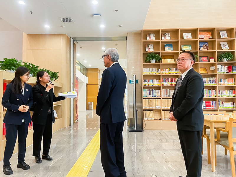 Picture 6: Dr. Tej Bunnag (center) and Mr. Piroon Laismit (right) listen to staff members providing information about projects.