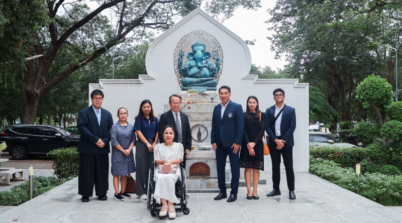 Participants pose for a group with the Ganesha sculpture.