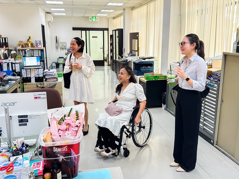 Picture 7: Ms. Nongnuch Maytarjittipun (center, seated in a wheelchair) guides Ms. Kingkarn Siriwat (left) and Ms. Nitwari Sikon (right) to the APCD office