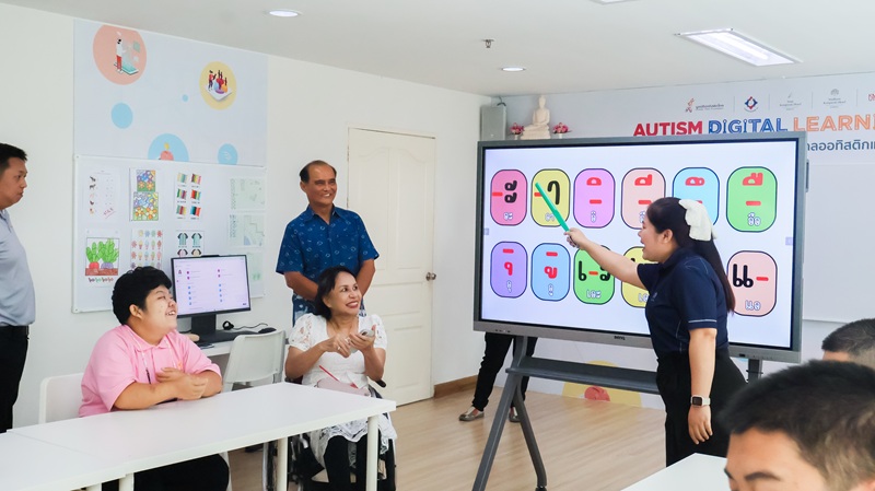 Picture 7: Ms. Nongnuch Maytarjittipun (center, seated in a wheelchair) and Mr. Pramote Thammasaroch (standing behind Ms. Nongnuch Maytarjittipun) attend a Thai language class for persons with autism