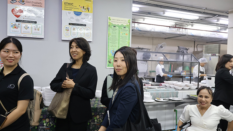 Picture 9: From left Ms. Ikeuchi Ami – JOCV; Ms. Sato Hiromi - Representative; Ms. Ichigi Akari - Representative; and Ms. Nongnuch Maytarjittipun (seated in a wheelchair) visiting the Kitchen  Department.