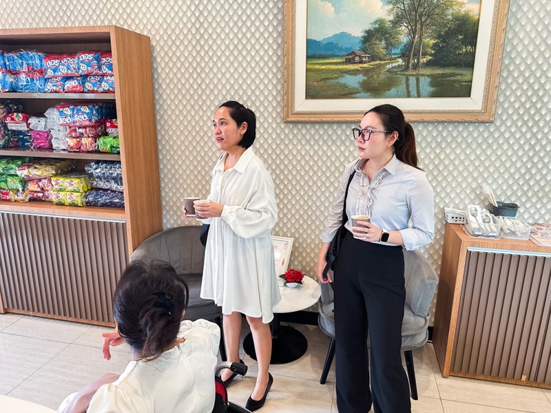 Picture 9: Ms. Nongnuch Maytarjittipun (left, seated in a wheelchair) guides Ms. Kingkarn Siriwat (center) and Ms. Nitwari Sikon (right) to the 60+ Plus Kitchen