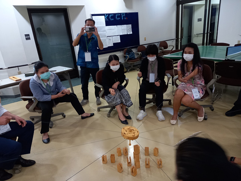 KCCP training participants play SAMSPEL, another inclusive sport for persons with and without disabilities. Participants must work together to stack blocks on top of one another by pulling a string in unison.