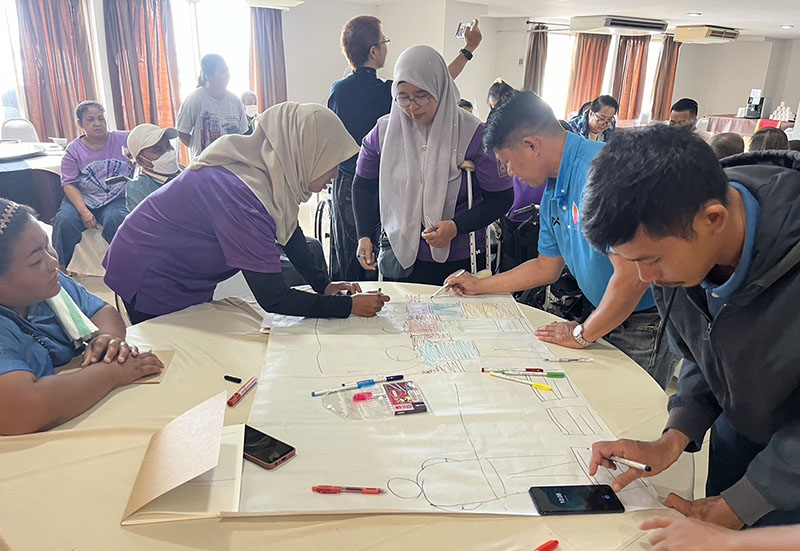 Participants with physical disabilities actively engaging in the DET session to enhance empowerment and advocacy for persons with disabilities.