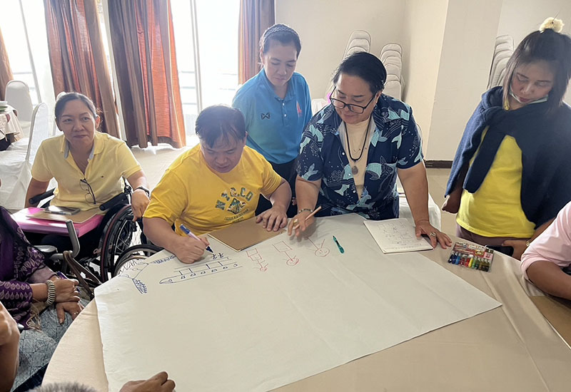 Participants with physical disabilities actively engaging in the DET session to enhance empowerment and advocacy for persons with disabilities.