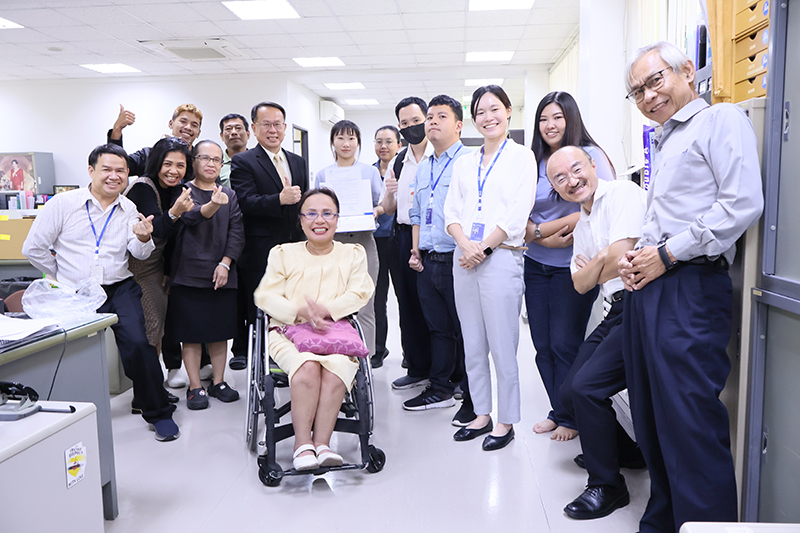 A group photo highlighting Ms. Valora, Mr. Piroon Laismit, and APCD staff.