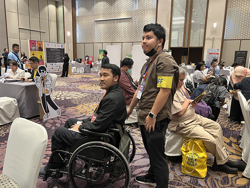 Mr. Chayoot Homdee, Community Development Officer, APCD volunteered assist and accommodate persons with disabilities during the event. 