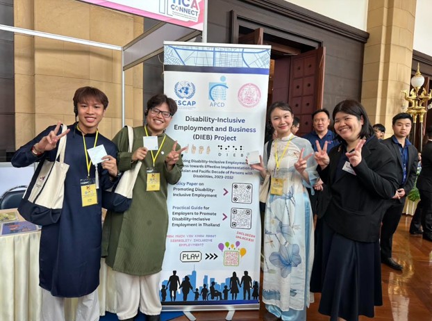Picture 6: Vietnamese students visited the APCD booth and exchanged information about the Disability-Inclusive Employment and Business (DIEB) Project. They also took a cute group photo with APCD staff while wearing their traditional attire.