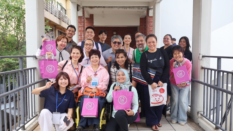 Participants joined Ms. Thorfan for a group photograph after they purchased APCD chocolate and bakery products in support of inclusive workplace initiatives.