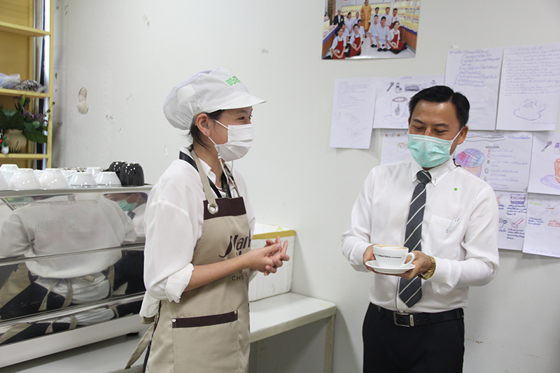 As one of the processes of service training, Mr. Wuthisak received a cup of coffee from a trainee.