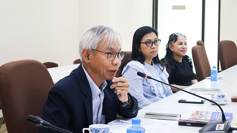 Picture 4: Mr. Somchai Rungsilp speaks through a microphone at the conference table, with Ms. Wilailekha Somprach and Ms. Nongnuch Maytarjittipun seated in the background.