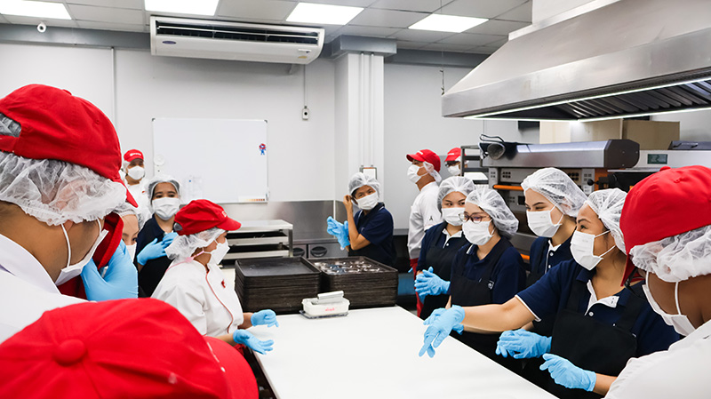 Picture 2: Group photo of team members from Millennium Hilton Bangkok baking the bakeries with persons with disabilities.