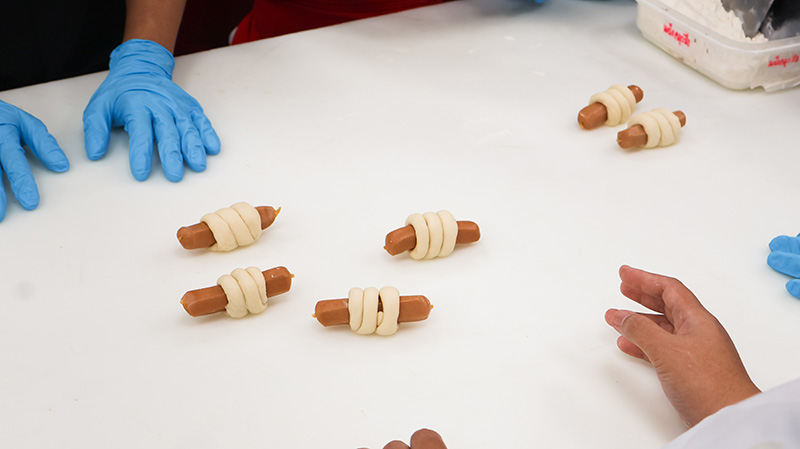 Picture 4: Rolled sausage doughs ready to be baked in the oven.
