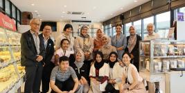 Group photo of students, lecturers, and APCD staff at the 60+ Plus Bakery & Chocolate Café.