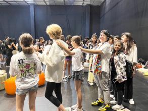 Ms. Supaanong Panyasirimongkol and students warm up by playing rock paper scissor line as to know each other before her speech.