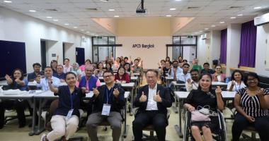 Participants pose for a group photo at the APCD training building.